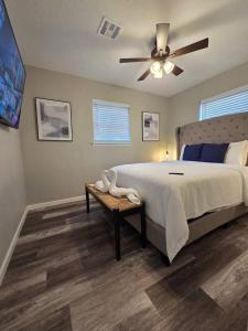 a bedroom with a bed and a ceiling fan at Brand new everything! Adjustable beds! Best House in Lawton