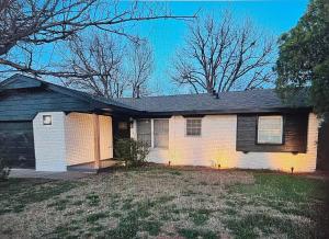 a brick house with a black roof at Brand new everything! Adjustable beds! Best House in Lawton