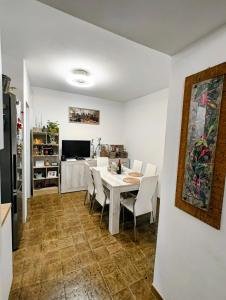 a kitchen and dining room with a white table and chairs at Alloggio DON ESTEBAN in Santa Maria della Versa
