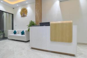 a lobby with a reception desk and a couch at Aceotel Select Virat, Vijay Nagar in Indore