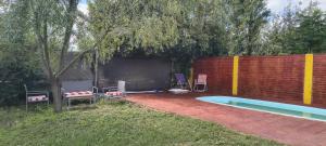 a backyard with a fire pit and a swimming pool at Cabaña Puntana in La Punta