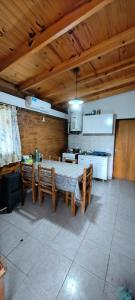 a dining room with a table and chairs in a kitchen at Cabaña Puntana in La Punta