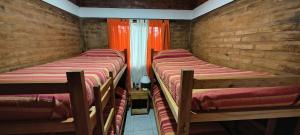 a group of three beds in a room at Cabaña Puntana in La Punta +7 photos