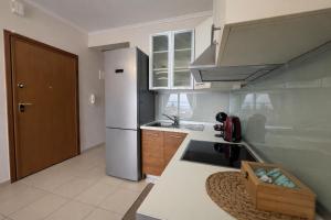 a kitchen with a sink and a refrigerator at MK Seaview Stays in Neos Marmaras +2 photos