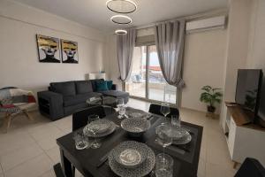 a living room with a table with wine glasses on it at MK Seaview Stays in Neos Marmaras