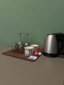 a tray with a tea pot and a toaster at The Orso Suite -Brera in Milan