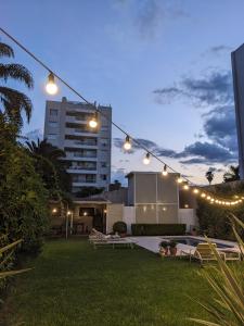 a string of lights hanging over a yard at night at Delvino Boutique Hotel in Salta