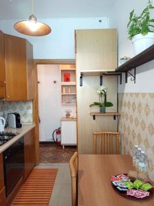 a kitchen with a wooden table in a room at La Yucca in Dolceacqua