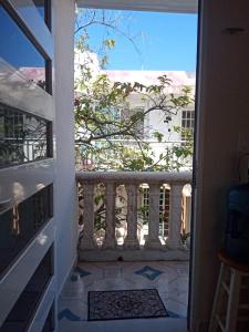 an open door to a balcony with a view of a building at Hermoso apartamento nuevo in Isla Mujeres