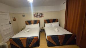 two beds in a small room withacers at The ultimate group stay in Catford