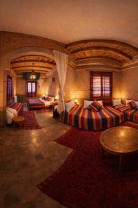 a large room with couches and tables in a building at Riad Des Vieilles Charrues in Boumalne Dades +131 photos