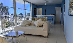 a living room with a couch and a balcony at Henrietta Place B&B in Progreso