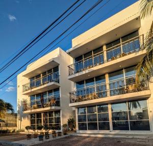 an apartment building with balconies on the side of it at Henrietta Place B&B in Progreso