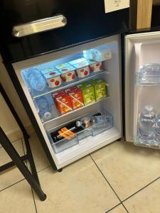 an open refrigerator filled with food and drinks at Agata House in Catania