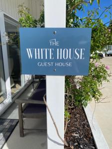 a sign for the white house guest house at The White House Guest House in Big Omaha