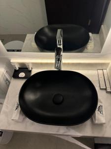 a black toilet on a counter in a bathroom at Princess House in Jeddah +9 photos