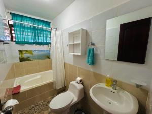 a bathroom with a sink and a toilet and a tub at Ocean View Lodge in Cahuita +38 photos