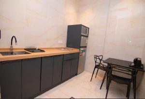 a kitchen with a counter and a sink and a table at Princess House in Jeddah