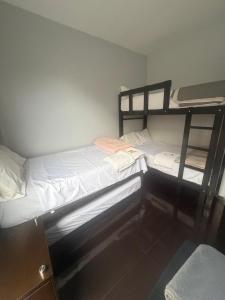 two bunk beds in a small room with a window at Miraflores Alcanfores in Lima