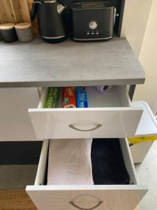 a drawer in a desk with food and a pot at Friends With Bienefelts in Turners Beach