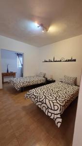 two beds in a room with at Can Blum in La Asomada