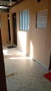 a room with a door and a tile floor at Pousada Vó Ana Reis in Aparecida