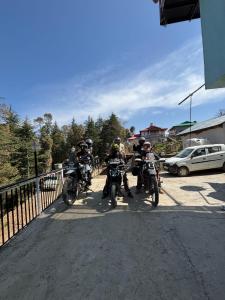 a group of people riding motorcycles on a road at Deodar hill top home stay chail in Chail +7 photos