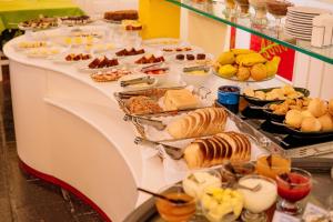 a buffet line with different types of pastries and desserts at Hotel Pousada da Neve in Nova Petrópolis