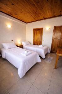 a bedroom with two beds and a wooden ceiling at Hotel Italia in Ovalle