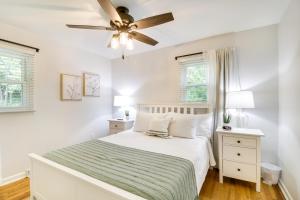 a white bedroom with a bed and a ceiling fan at Papas Cottage Hot Tub Near Nelson 151 in Afton