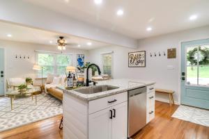 a kitchen with a sink and a living room with a couch at Papas Cottage Hot Tub Near Nelson 151 in Afton