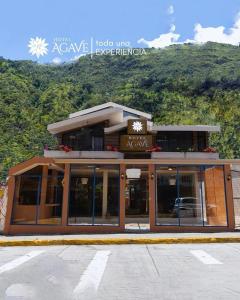 a building with a sign that reads acave lodge inn at Hotel Casa Agave in Baños