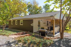 a tiny house with a porch and a patio at Papas Cottage Hot Tub Near Nelson 151 in Afton