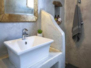 a bathroom with a white sink and a mirror at Kalafatis Stay with Private Pool in Kalafatis +18 photos
