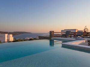 a swimming pool with a view of the ocean at Kalafatis Stay with Private Pool in Kalafatis