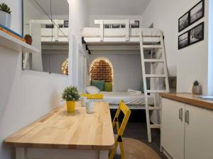 a room with a table and a bunk bed at Mykonos Town Home for Two in Megali Ammos