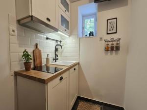 a small kitchen with a sink and a counter at Mykonos Town Home for Two in Megali Ammos +6 photos