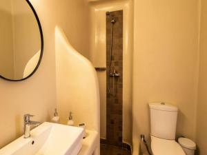 a bathroom with a sink and a toilet and a mirror at Ano Mera Villa with Private Pool in Ano Mera +7 photos