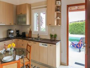 a kitchen with a glass table and a dining room at Ano Mera Villa with Private Pool in Ano Mera