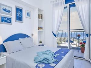 a bedroom with a bed with a view of the ocean at Rhodes Retreat with Private Pool in Kalathos +9 photos