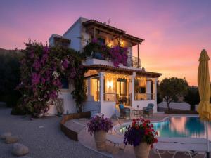 a villa with a pool in front of a house at Rhodes Retreat with Private Pool in Kalathos