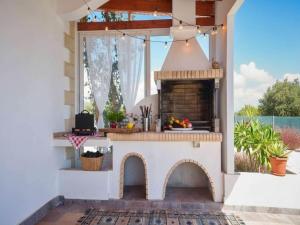 a outdoor kitchen with a fireplace on a patio at Rhodes Retreat with Private Pool in Kalathos