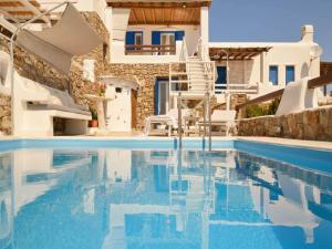 a villa with a swimming pool in a resort at Panormos Retreat with Pool in Mikonos