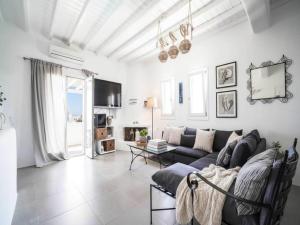 a living room with a couch and a table at Panormos Stay for Seven Guests in Mikonos