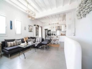 a living room with a couch and a table at Panormos Stay for Seven Guests in Mikonos