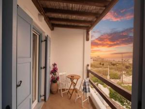 a balcony with a view of a sunset at 3-Bed Home in Ano Mera in Ano Mera