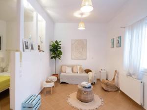 a living room with a couch and a table at 3-Bed Home in Ano Mera in Ano Mera
