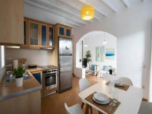 a kitchen and living room with a table and chairs at 3-Bed Home in Ano Mera in Ano Mera