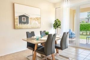 a dining room with a table and chairs at Solimar Villa Family Vacation Spot in Playa de Guayanes +9 photos