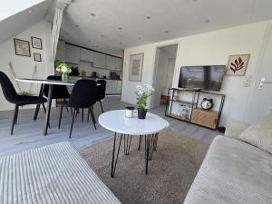 a living room with a couch and a table at Lovely Home For You 2 in Biberach an der Riß